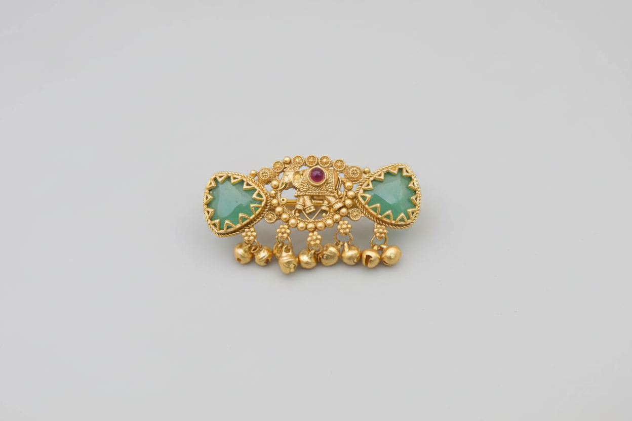 Antique gold-plated statement ring featuring a central elephant motif, two triangular green jade-style stones, and hanging gold bell charms