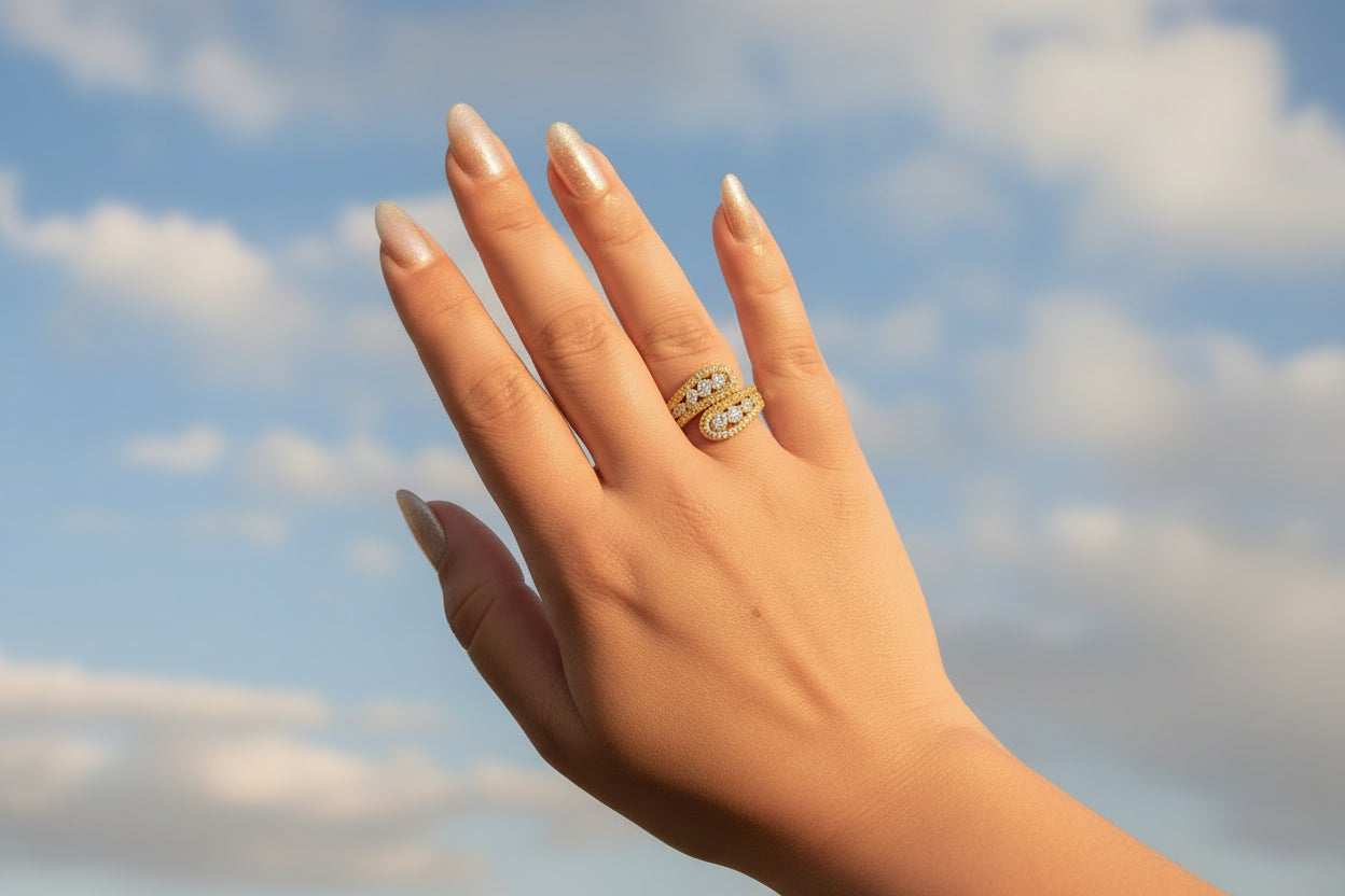 Hand wearing a diamond ring on a textured green surface