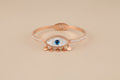 Bracelet with an eye design with rose gold band 