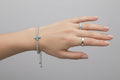 Hand with a ring and bracelet on a dark background