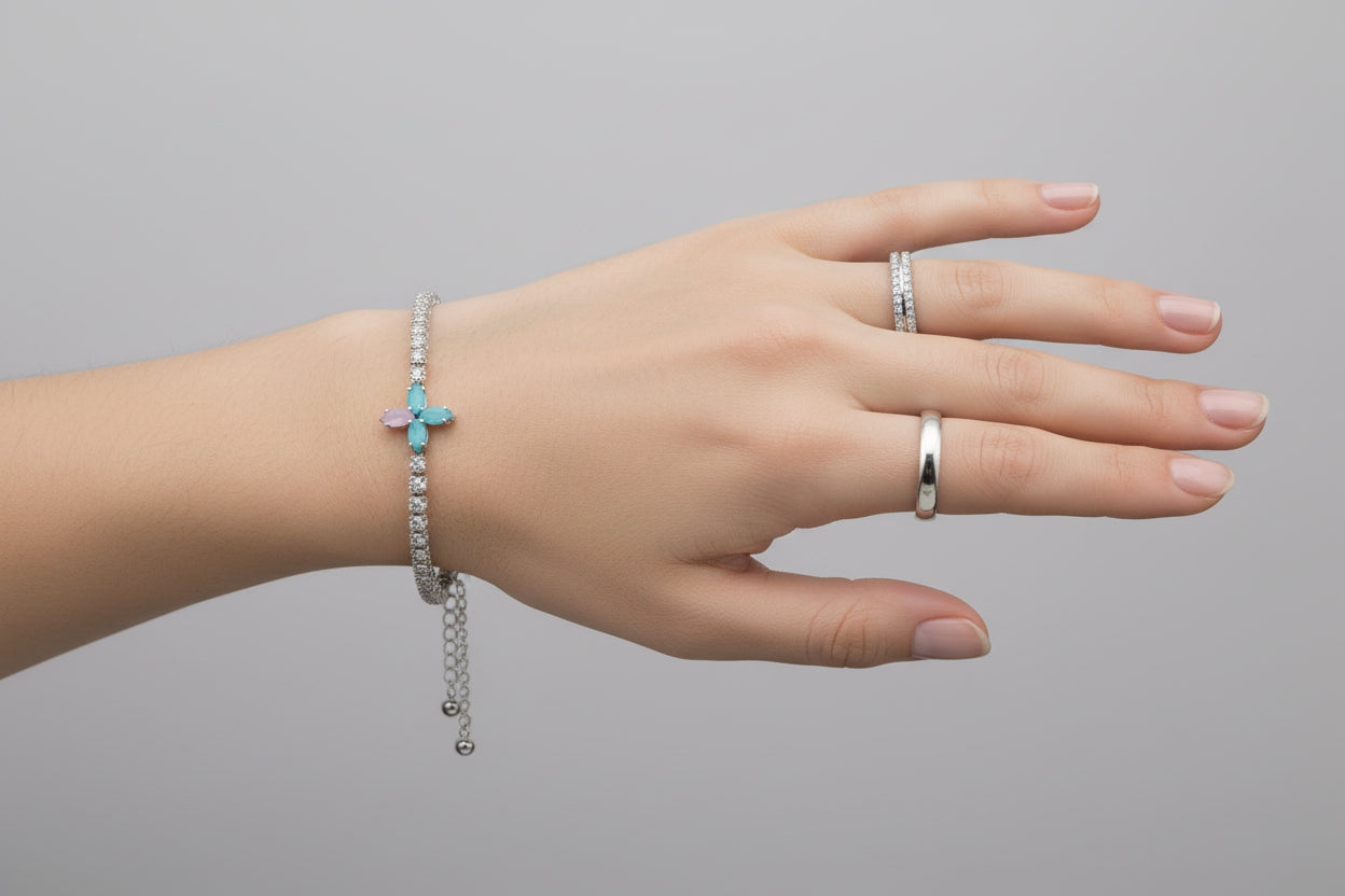Hand with a ring and bracelet on a dark background
