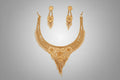 Ornate necklace and earrings set on a black background