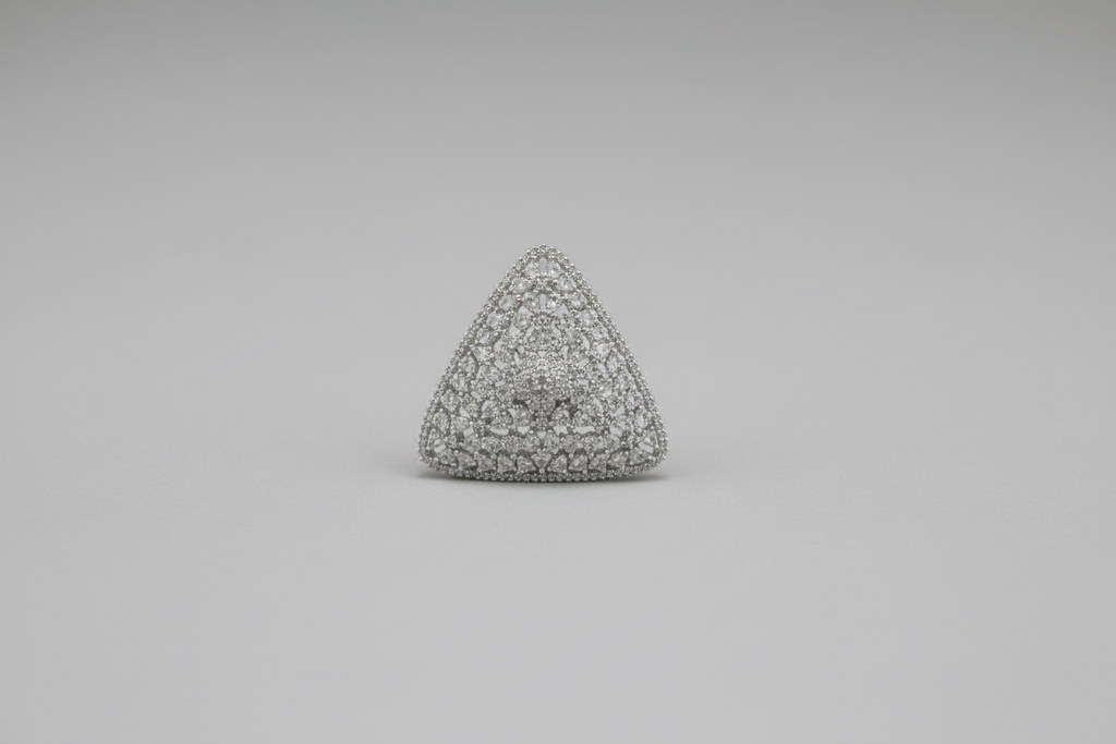Triangular textured object held in a hand against a black background