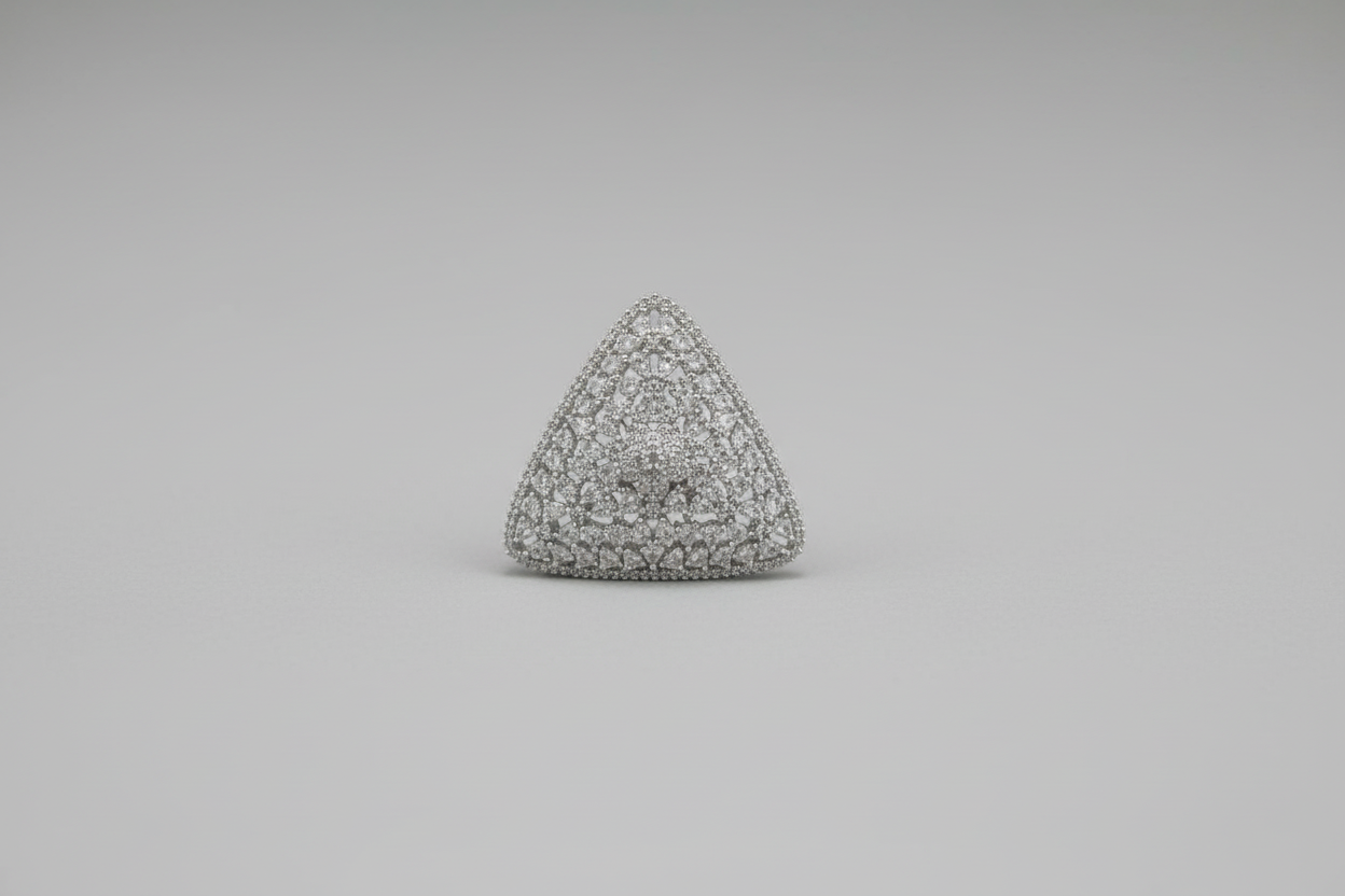 Triangular textured object held in a hand against a black background