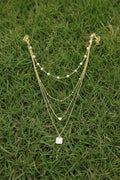 Multi-strand gold necklace for women featuring pearl beads, heart pendant, and square stone