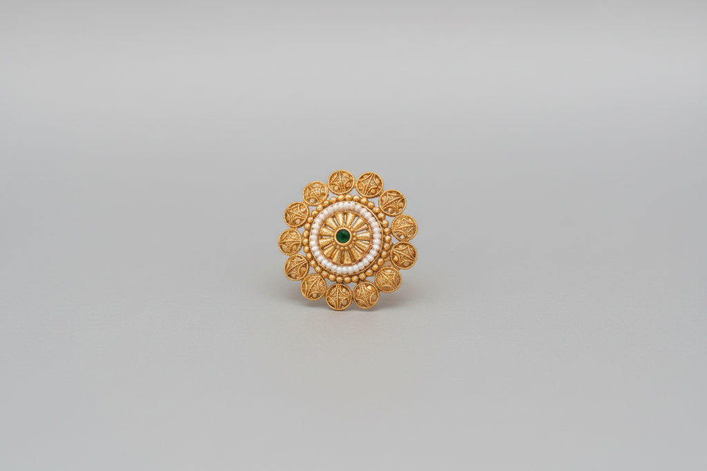 Traditional gold-finish cocktail ring with white pearl accents and a green center stone, showcasing a sunburst or floral design